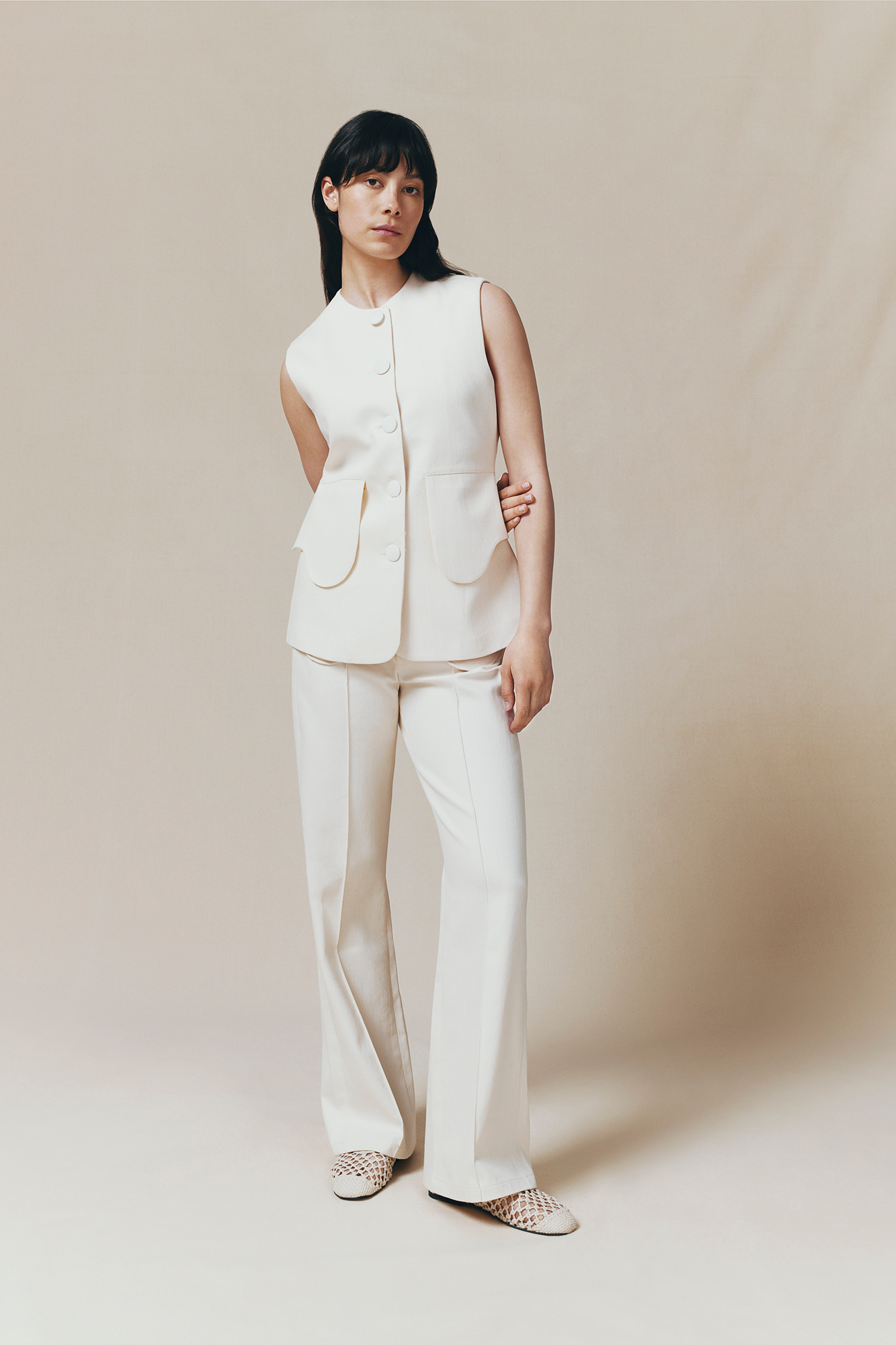 Denim ecru flared pants with circular pocket details