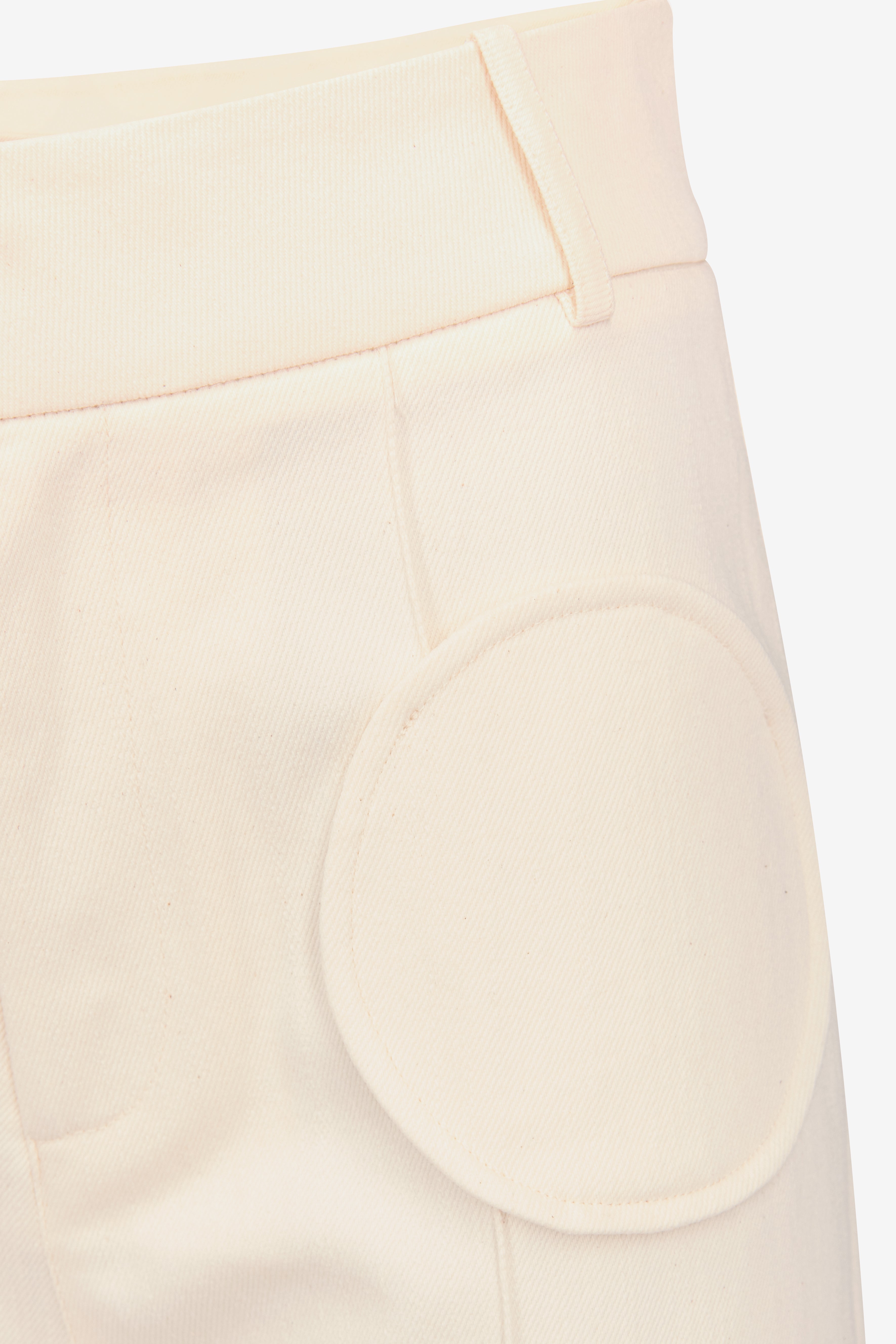 Denim ecru flared pants with circular pocket details
